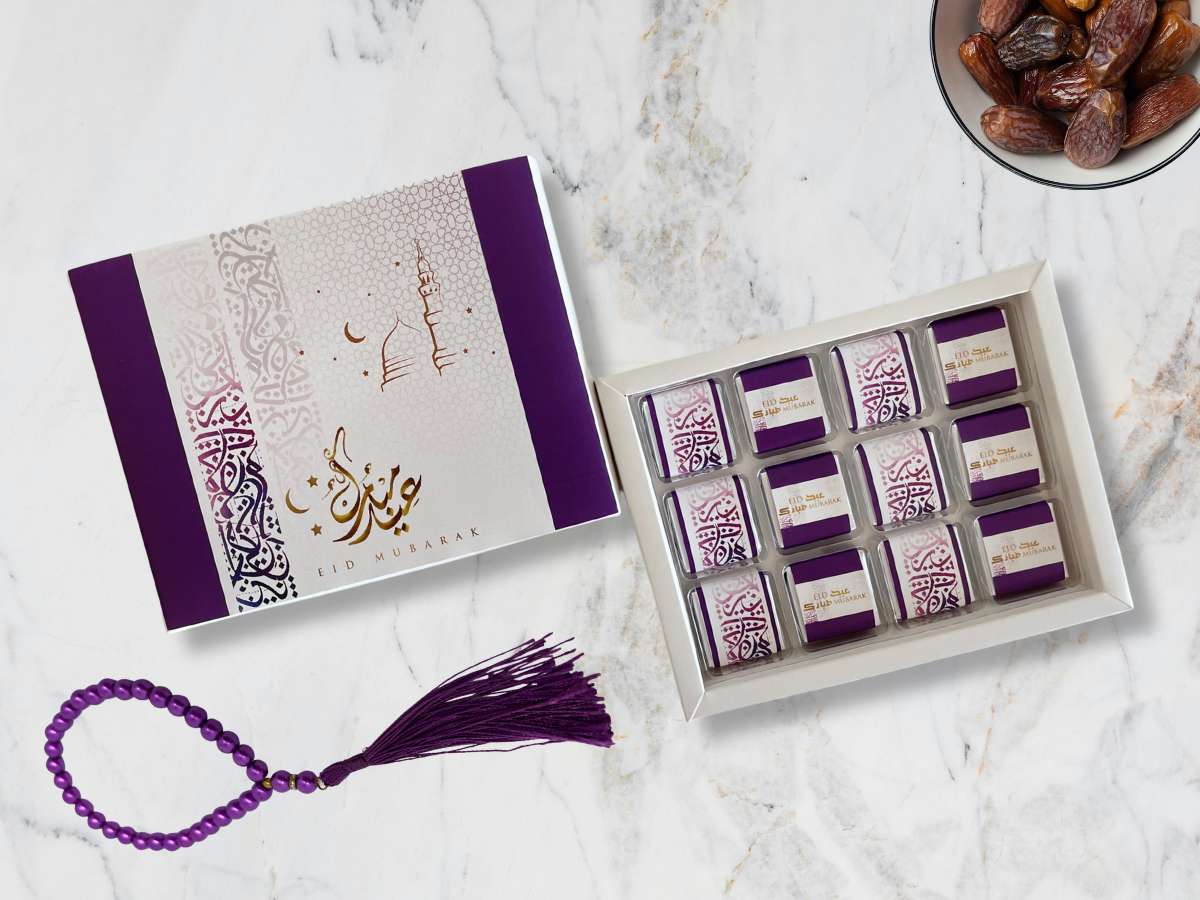 Box of chocolates with a purple tassel on a marble surface