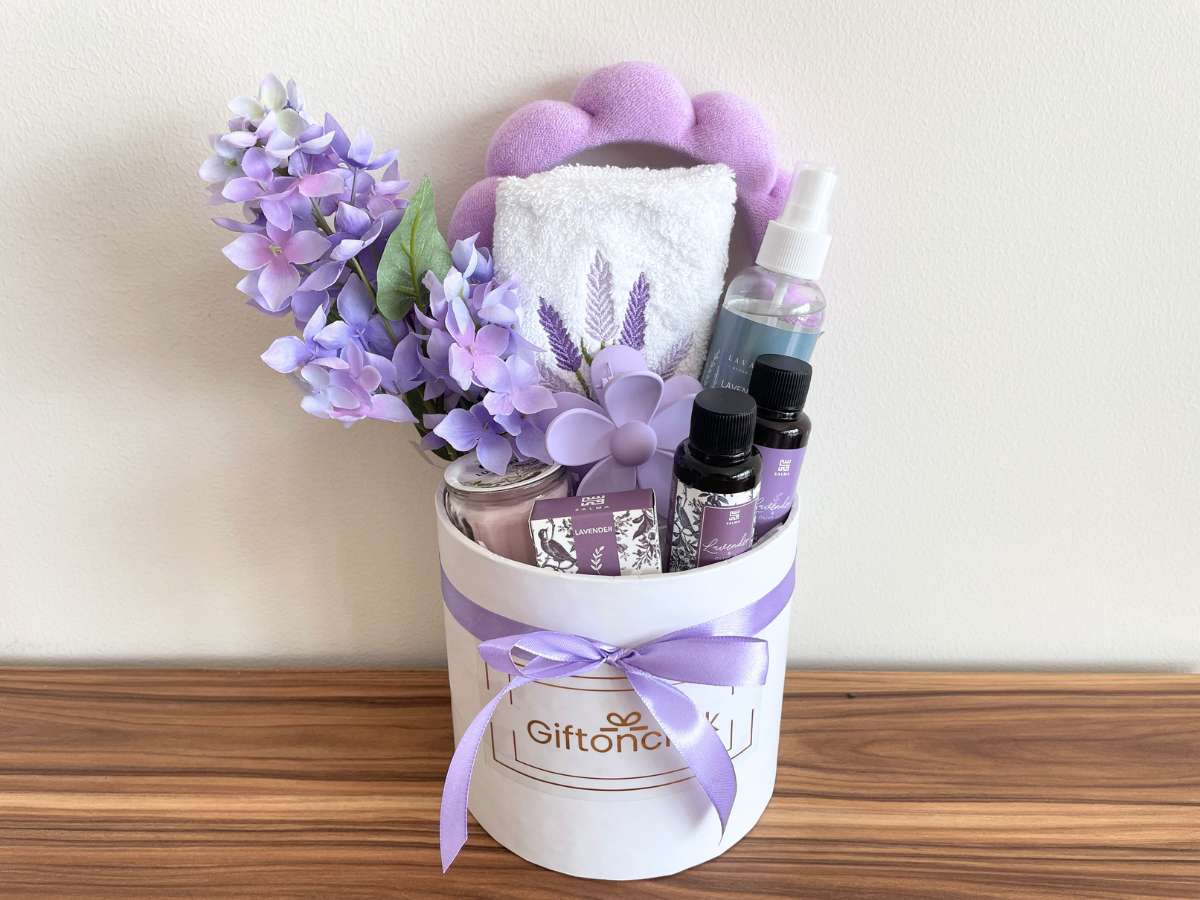 Lavender relaxation gift box with candle, essential oils, lavender flowers and spa accessories in luxury packaging