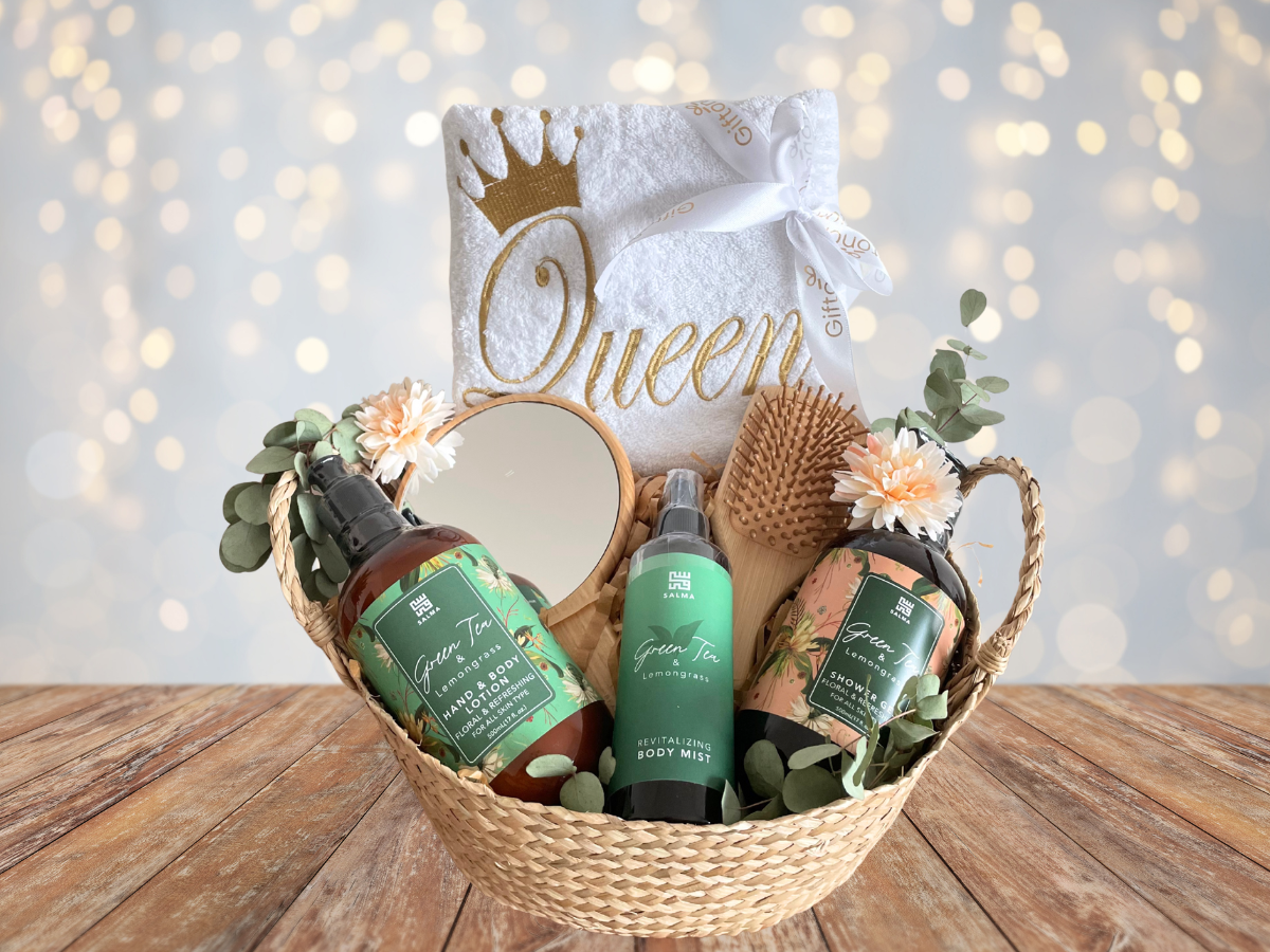Basket of beauty products with 'Queen' towel in the background